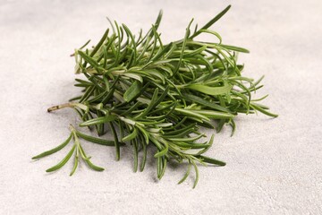 Fresh green rosemary on light textured table