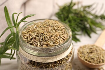 Dry and fresh rosemary against blurred background, closeup