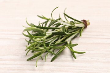 Fresh green rosemary on white wooden table, closeup