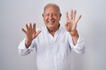 Naklejka premium Senior man with grey hair standing over isolated background showing and pointing up with fingers number nine while smiling confident and happy.
