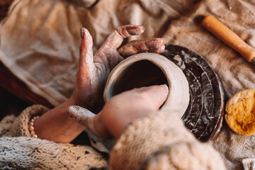 Female sculptor making clay mug in a home workshop,hands close-up.Small business,entrepreneurship,hobby, leisure concept.