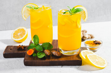Ginger and Turmeric Lemonade, Healthy Refreshing Beverage with Turmeric Root and Spices, Jamu...