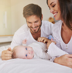 Happy family, baby and parents on bed for love, care and quality time together in house. Mom, dad and cute newborn kid relax in bedroom of home for childhood development, caring support and happiness