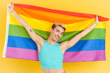 Proud gay man raising a lgbt rainbow flag