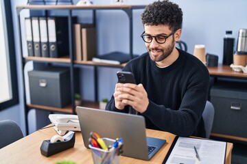 Young arab man business worker using smartphone working at office