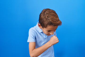 Little hispanic boy wearing casual blue t shirt feeling unwell and coughing as symptom for cold or bronchitis. health care concept.