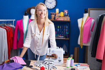 Young blonde woman tailor smiling confident standing at sewing studio