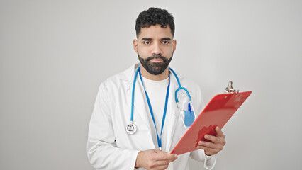 Young hispanic man doctor reading document on clipboard over isolated white background