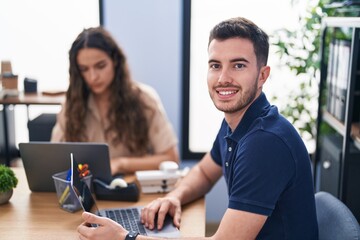 Fototapeta premium Young hispanic couple business workers using laptop working at office