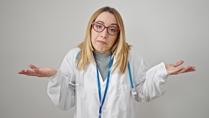 Young blonde woman doctor standing clueless over isolated white background