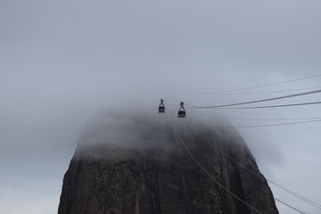 Cable car cars going up Sugar Mountain in the fog in Rio de Janeiro