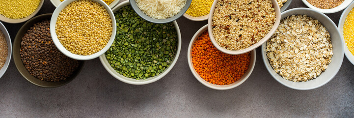 Various grain cereals in bowls banner, top view