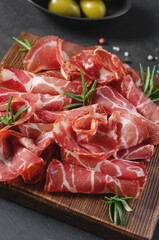 Cured Meat Platter, Coppa with Spices, Italian Antipasto, Appetizer over Dark Background
