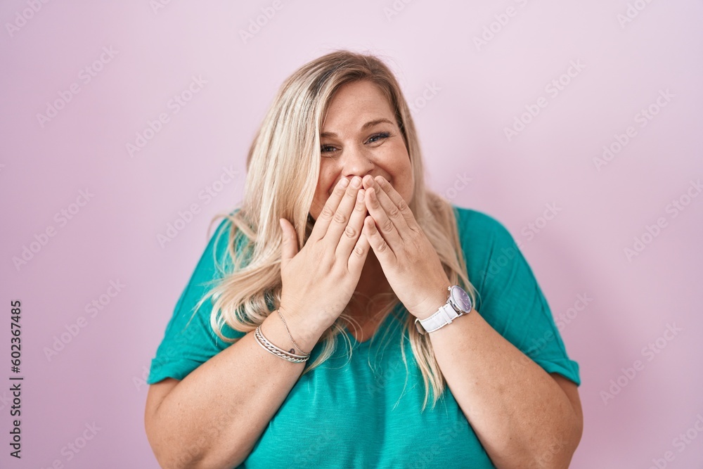 Sticker Caucasian plus size woman standing over pink background laughing and embarrassed giggle covering mouth with hands, gossip and scandal concept