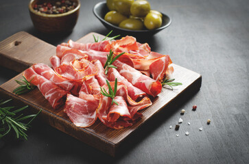 Cured Meat Platter, Coppa with Spices, Italian Antipasto, Appetizer over Dark Background