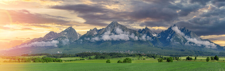 Panoramic view of Tatra mounains. Landscape of High Tatras in the spring. Snowy mountain tops and...