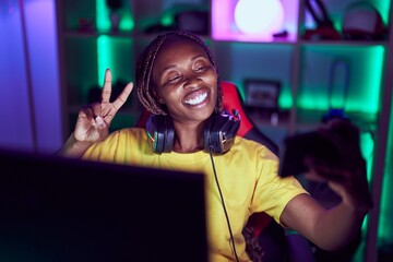 African american woman streamer smiling confident make selfie by smartphone at gaming room