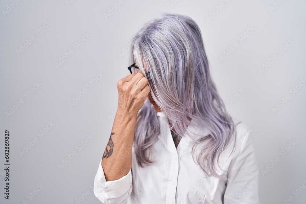 Canvas Prints middle age woman with tattoos wearing glasses standing over white background tired rubbing nose and 