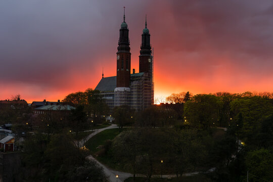 Beautiful panoramic night view of the famous Hogalid church on city park hill with dramatic sunset sky in Stockholm.