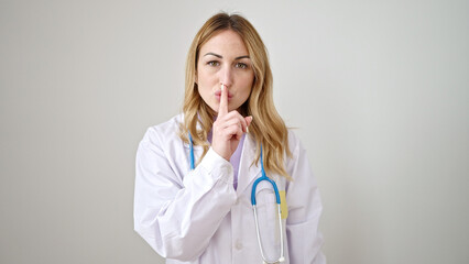 Young beautiful hispanic woman doctor asking for silent over isolated white background