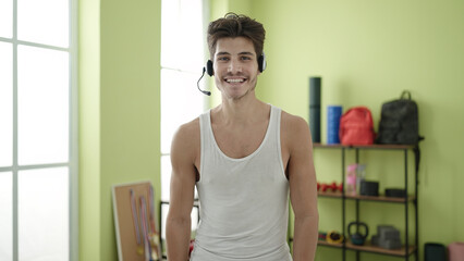 Young hispanic man personal trainer smiling confident at sport center