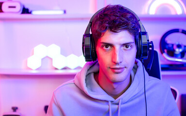 Portrait handsome young male game online streamer, caster, smiling, looking at camera, compete...