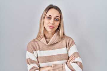 Young blonde woman wearing turtleneck sweater over isolated background looking sleepy and tired, exhausted for fatigue and hangover, lazy eyes in the morning.