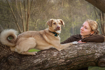 Portrait of beautiful blonde girl with a dog