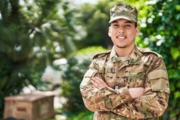 Young man army soldier standing with arms crossed gesture at park