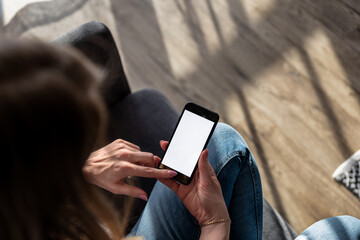 woman holding a smartphone with a blank screen, representing the concept of technology and a smart...