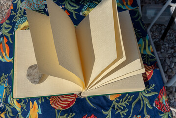 Braille book with stone as a bookmark on the beach