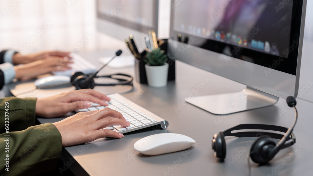 Aufkleber panorama focus hand holding headset on call center workspace desk with blur background of operator t