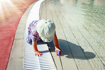 a happy child plays by the pool on the nature by the sea