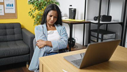 African american woman business worker stressed sitting with arms crossed gesture at office