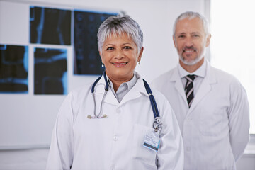 Senior team of doctors in portrait, smile in radiology with woman in leadership and man in hospital. Surgeon, healthcare and medical professional people in collaboration, happy working together