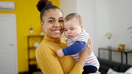 Mother and son smiling confident hugging each other at home