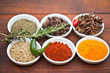 Food, turmeric and spices on table top for cooking gourmet meal, pepper seasoning or paprika flavor. Vegetables leaf, kitchen condiments and variety of plant herbs in bowls for brunch or healthy diet