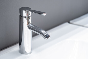 Stainless steel water tap or chrome faucet in the bathroom