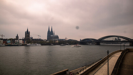 Cologne, Germany. Famous Hohenzollern Bridge over Rhine river. Buildings in historic city centre