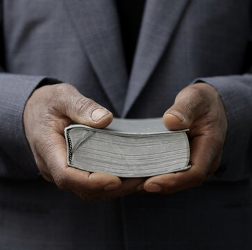 praying to God with hand on bible with people stock photo