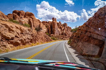 driving through arches national park desert landscape