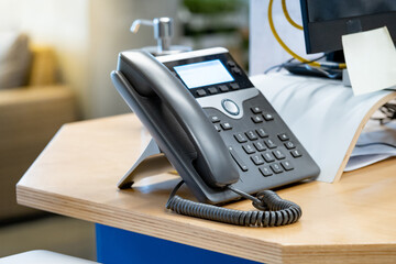 Landline VoIP telephone on office desk. Call center and customer service