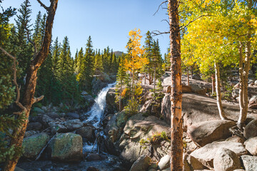 waterfall in the forest of rocky mountains at fall