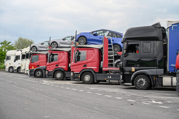 A group of trucks in a parking lot at a gas station. Drivers are resting. Transport by trucks.