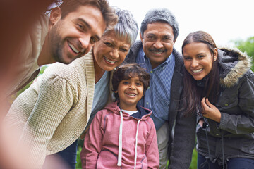 Selfie, smile and faces of a big family in nature on an outdoor adventure, travel together in portrait. Happy, love and boy child taking picture with grandparents and parents on holiday or vacation