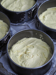 chef preparing white pink red cake creamy mixtures doughs to bake in the oven
