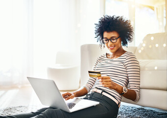 Young woman, laptop and credit card with bokeh doing online shopping sitting on ground. Home,...