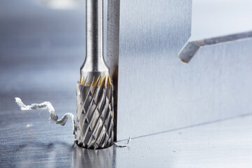 Obraz premium Milling cutter make sink in hole in steel billet. Locksmith work.