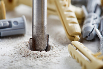 metal drill bit make holes in concrete wall with industrial drill. Building work industry.