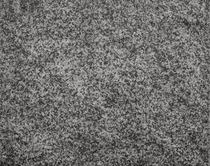Close-up of natural granite rock surface texture in black and white, front view. Abstract full frame textured background. Copy space.